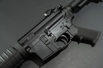 Close up view of black AR-15 on black background. 