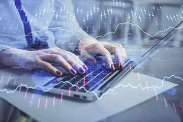 Multi exposure of woman hands typing on computer and financial graph hologram drawing. Stock market analysis concept.