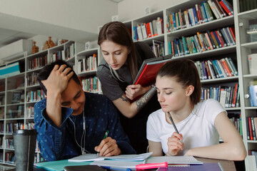 Young woman helping classmates with studies