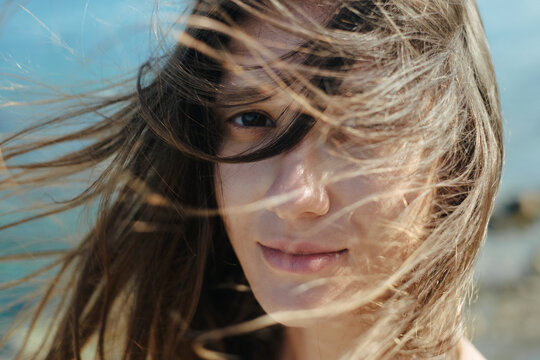 Young woman seaside windy portrait
