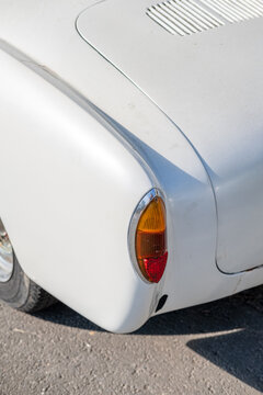 The taillight of a classic white car