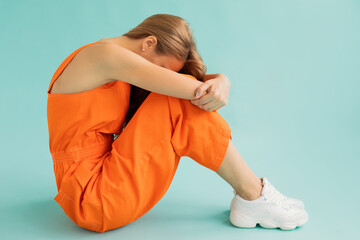 Abandoned female hiding face in arms