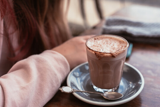 young teen in cafe with hot chocolate