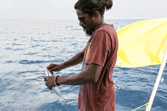 Maldivian man on a boat fishing
