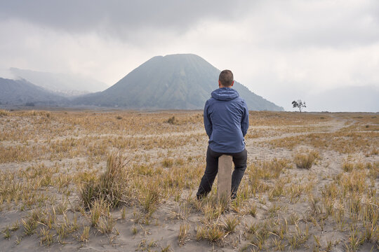 Man visiting Bromo volcano and taking a break.