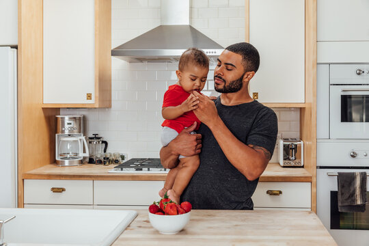 Man Feeds Son a Strawberry