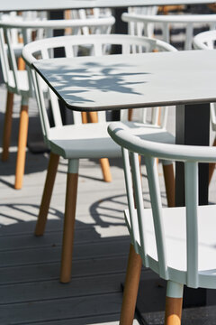 Wooden chairs painted in white at garden table