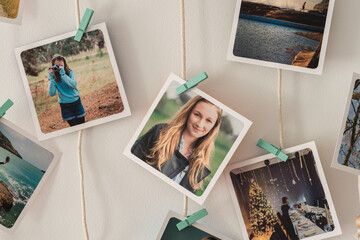 polaroids hanging on string frame