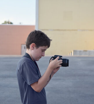 Young Boy Recoding with Camera Outside