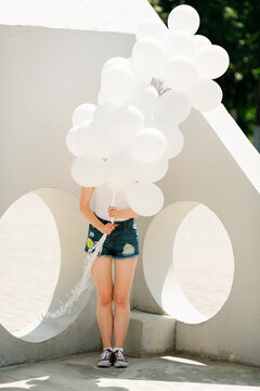 young woman with the white balloons