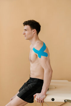Man sitting on table with one crossed blue types after rehabilit