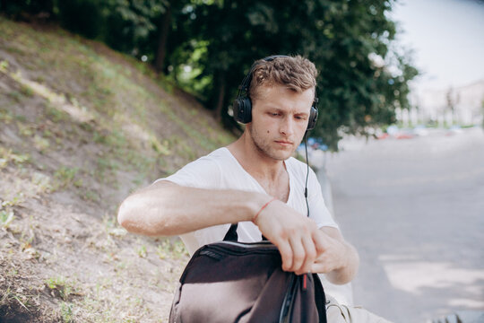 guy unfastens a backpack