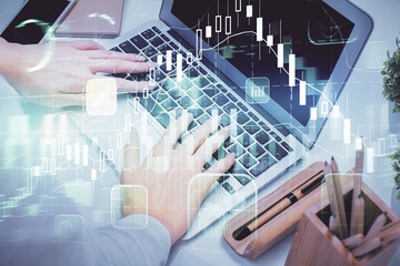 Double exposure of woman hands typing on computer and forex chart hologram drawing. Stock market invest concept.