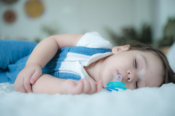 baby are sleeping on white bed at home