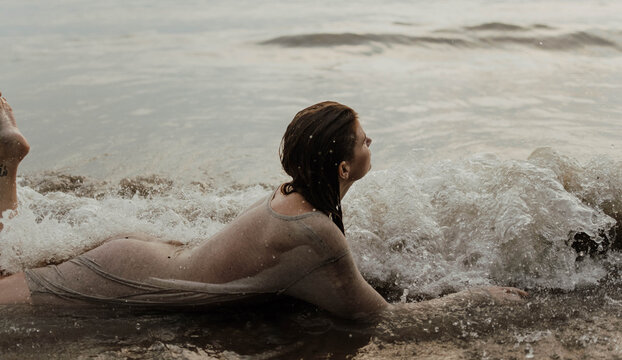 A woman at the beach at sunset