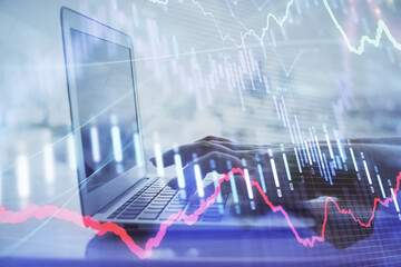 Double exposure of woman hands typing on computer and forex chart hologram drawing. Stock market analysis concept.