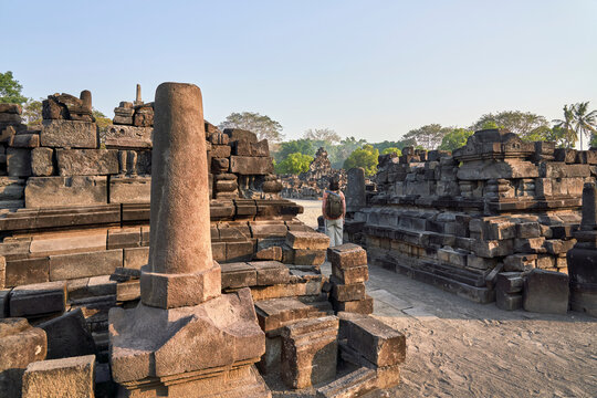 Back view of woman with backpack standing in Prambanan Temple, Java, Indonesia
