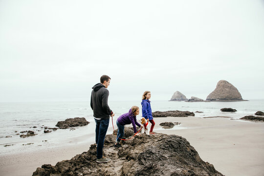 Family Climbing On Rocks