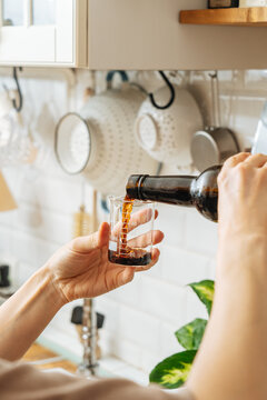 Cook measuring vinegar in glass cup