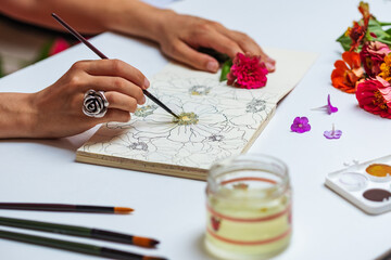 Anonymous Female Artist Painting With Watercolors Flowers On Sketch Pad