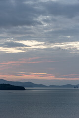 Beautiful first light from sunrise on island mountain with color sky 