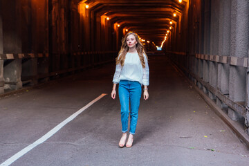 Young woman standing in a tunnel with lights