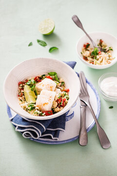 Couscous salad with herbs, tomatoes and cod fillet