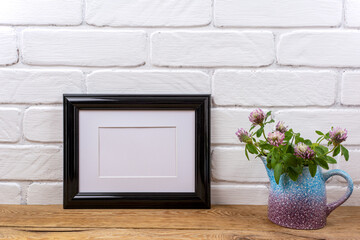 Black landscape frame mockup with pink clover