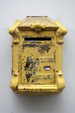 Old yellow public mailbox in France