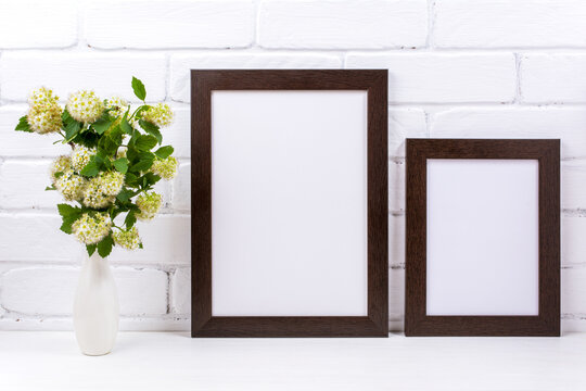 Two black brown poster frames mockup with spirea branch