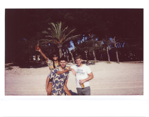 Friends with beer on the beach.
