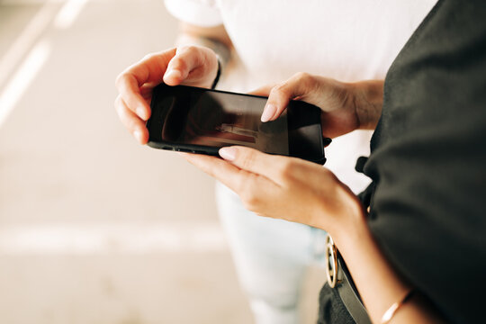 hands of two women with phone