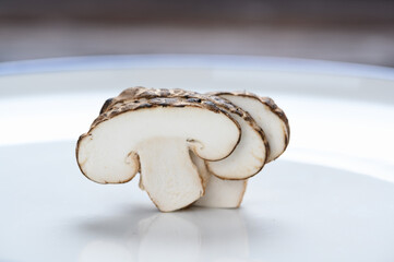 Shiitake mushrooms on the wooden background.