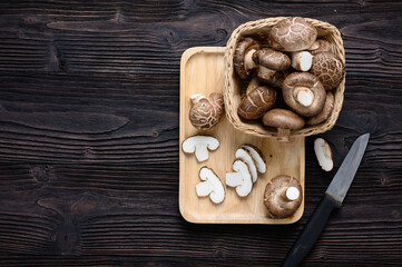 Shiitake mushrooms on the wooden background.