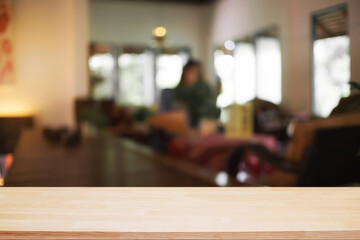 Empty wooden desk space and blurry background of coffee shop or Restaurant for product display montage.