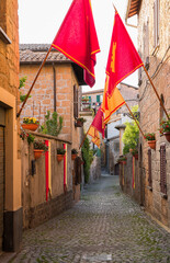 Colorful, narrow, cobblestone alley in Orvieto, Italy
