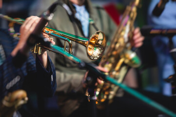 Concert view of a male trumpeter, professional trumpet player with vocalist and musical during jazz...