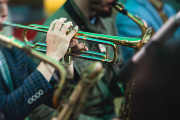 Concert view of a male trumpeter, professional trumpet player with vocalist and musical during jazz...