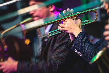 Concert view of a male trumpeter, professional trumpet player with vocalist and musical during jazz...
