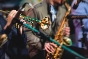 Concert view of a male trumpeter, professional trumpet player with vocalist and musical during jazz...