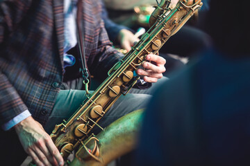 Concert view of a saxophonist, saxophone player with vocalist and musical during jazz orchestra...