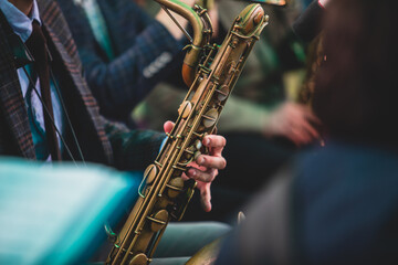 Concert view of a saxophonist, saxophone player with vocalist and musical during jazz orchestra...