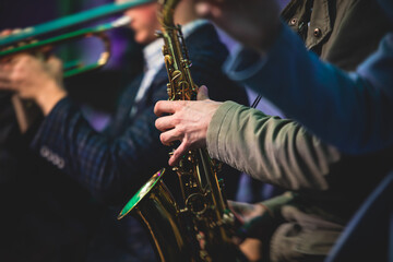 Concert view of a saxophonist, saxophone player with vocalist and musical during jazz orchestra...