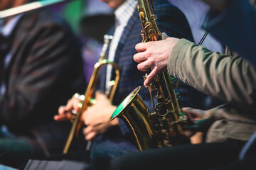 Concert view of a saxophonist, saxophone player with vocalist and musical during jazz orchestra...