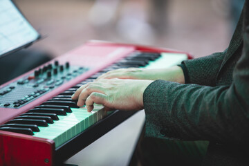 Concert view of a musical keyboard piano player during musical jazz band orchestra performing,...
