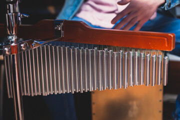 Percussionist drummer performing on mark tree, selective focus and close-up view on professional...