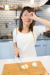 玉葱で目がしみる女性