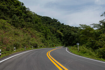 Fototapeta premium Rural Country Road on the Mountains early in the morning on the Doi Phuka National Reserved Park, Nan Province, Thailand