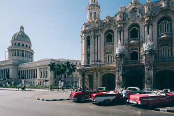 Havana, Cuba – 16 January, 2020: Famous colorful Taxis in Havana waiting for tourists to take a ride in a vintage car around major city attractions - obrazy, fototapety, plakaty