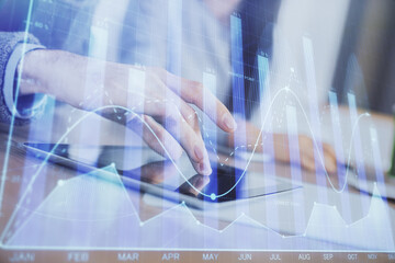 Double exposure of forex graph drawing and man and woman working together holding and using a mobile device. Trade concept.